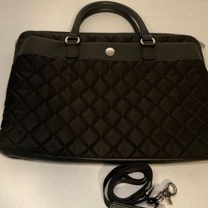 Knomo large black quilted laptop bag with removable shoulder strap.